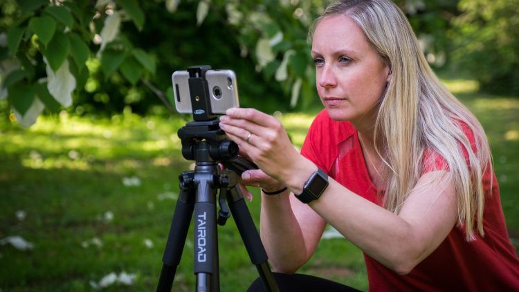 Helen Hyde lining up a shot on a phone on a tripod